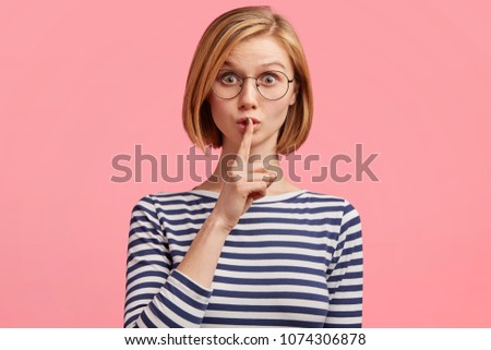 Stock fotó: Isolated Shot Of Attractive Secret Woman Keeps Fore Finger Over Lips Demonstrates Shush Gesture Te