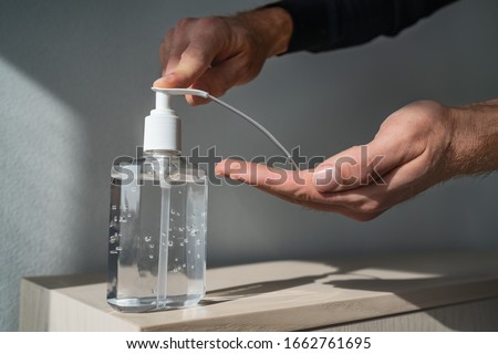 [[stock_photo]]: Corona Virus Hand Sanitizer Bottle Man Rubbing Gel Rub For Cleaning Hands Coronavirus Covid 19 Pande