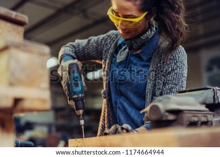 Stock photo: Female Worker With Electric Drill