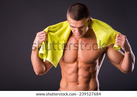 Stockfoto: Mid Section Of Shirtless Muscular Man Exercising With Dumbbell