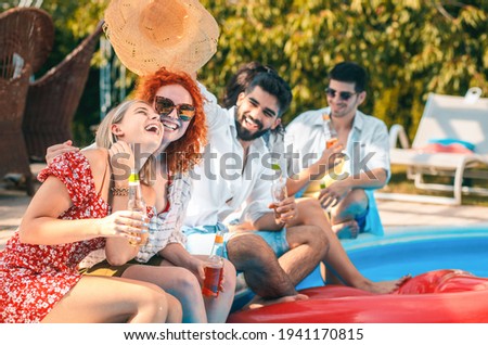 Stockfoto: Young People Drinking Cocktails By The Swimming Pool And Relaxin