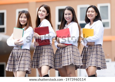 Stock photo: Cheerful Young Woman Running And Looking Back In Corridor