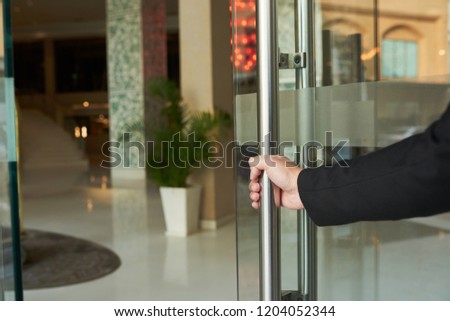 Stockfoto: Crop Helpful Man Opening Doorway For Guest