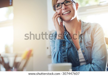Stok fotoğraf: Positive Young Woman Talking On Phone