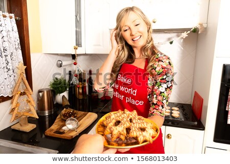Zdjęcia stock: Woman Hands A Festive Plate Of Star Cookies To A Guest
