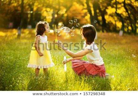 Stock fotó: Young Children Blowing Bubbles In The Woods