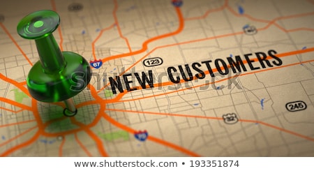 Foto stock: New Solutions - Green Pushpin On A Map Background