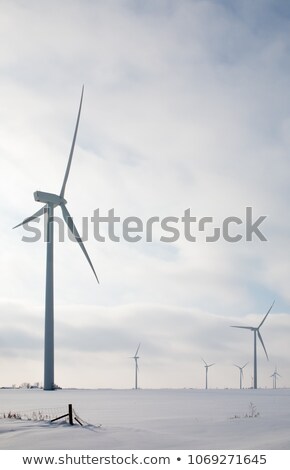 Stok fotoğraf: Wind Generators With Snow Covered Fields And Cloudy Sky