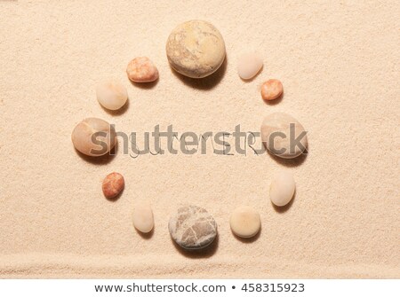 Stockfoto: Clock Drawn On A Stone On The Sand Of A Beach