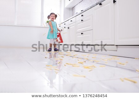 Сток-фото: Cute Girl Throwing French Fries On Floor