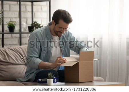 [[stock_photo]]: Man Unpacking The Goods