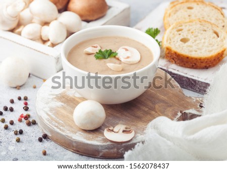 Foto stock: Wooden Plate Of Creamy Chestnut Champignon Mushroom Soup With Wooden Spoon Pepper And Kitchen Cloth