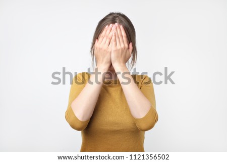 Photo Of Pretty Woman Covering Her Face And Expressing Surprise Foto stock © Koldunov