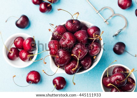 Foto stock: Fresh Ripe Black Cherries In A White Bowl On A Blue Stone Background Copy Space Top View