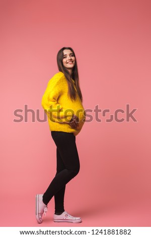 Stok fotoğraf: Emotional Young Woman Posing Isolated Over Pink Background Holding Rainbow Umbrella