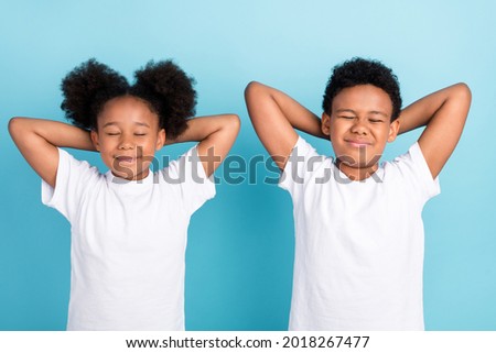 Foto stock: High Angle View Of A Mixed Race Schoolgirl Relaxing In The School Playground On A Sunny Day