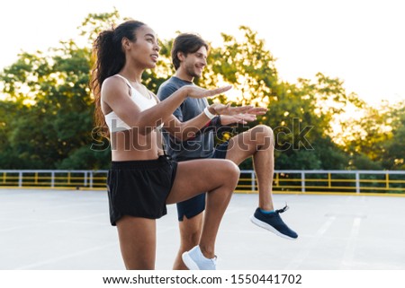 Stock photo: Photo Of Attractive Smiling Couple Doing Exercises While Working Out