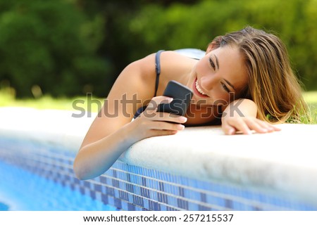 Foto stock: Young Beautiful Woman On The Side Of The Pool Playing With Water