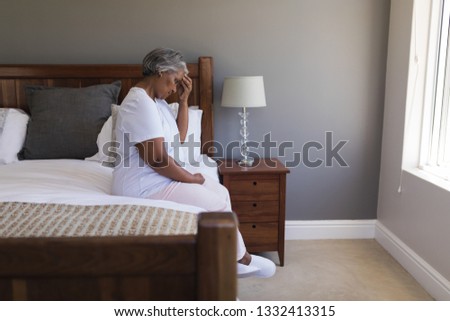 Stock fotó: Side View Of Worried Senior African American Woman Sitting On A Bed At Home