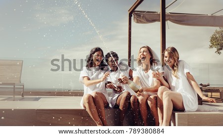 ストックフォト: Young Woman Holding Bottle Of Champagne While Sitting On Empty Bathtub