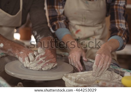 Сток-фото: Mid Section Of Man Assisting Woman In Molding Clay