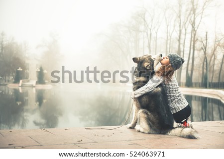 Foto d'archivio: Girl With A Puppy Outdoors In Winter