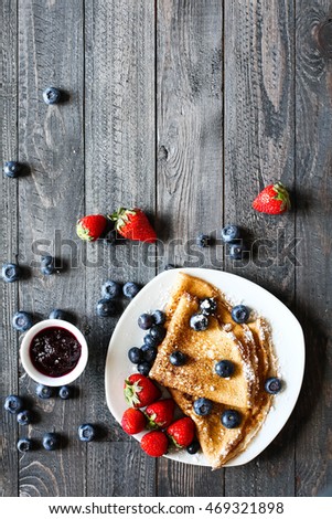 Stok fotoğraf: Delicious Crepes Breakfast With Dramatic Light Over A Wood Background