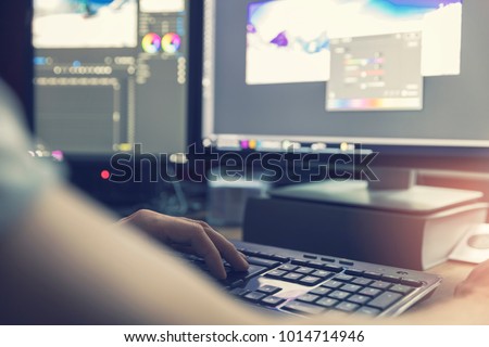 Сток-фото: Post Production - Man Doing Photo And Video Editing On Computer