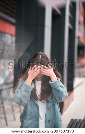 Zdjęcia stock: Portrait Of Young Brunette Woman Making Face Hiding Her Ears Listening Music In Headphones Wearin