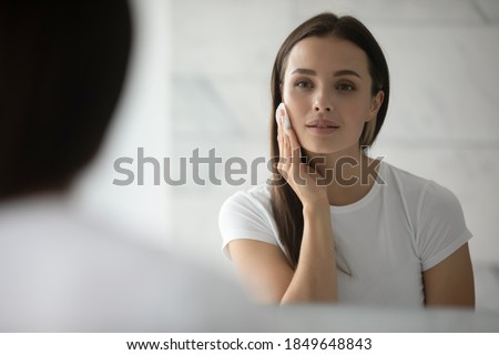 Foto stock: Happy Young Woman Applying Lotion