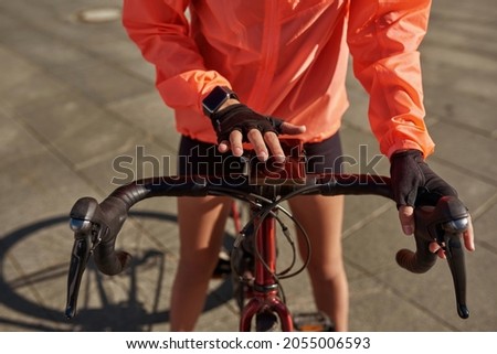 ストックフォト: Cropped View Of A Young Woman Using An Exercise Bike In The Gym