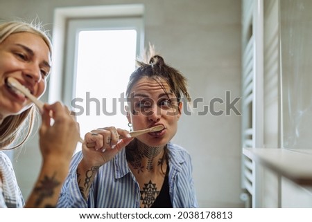 Stok fotoğraf: Lesbian Women Living Together Brushing Teeth In Bathroom At Home