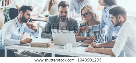 Stock foto: Smiling Ethnic Colleagues At Working Desk