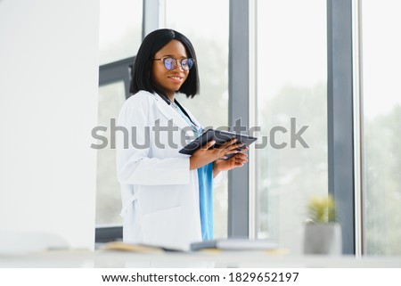 [[stock_photo]]: Portrait Of A Doctor Standing Up With The Arms Crossed Against A White Background