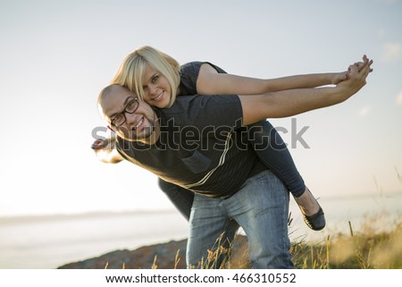 Beautiful Couple At The Sunset Habing Fun On Seaside Foto d'archivio © Lopolo