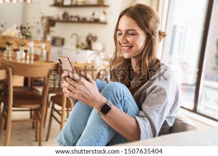 Foto stock: Pretty Redhead Using A Mobile Phone