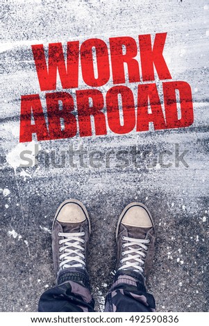 Stok fotoğraf: Work Abroad Title On The Pavement