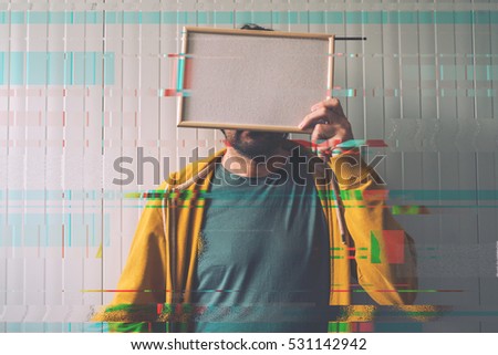 Stock fotó: Unrecognizable Man Posing With Blank Picture Frame Over His Face