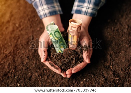 Foto stock: Hands With Fertile Soil And Euro Money Banknotes