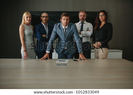 Stockfoto: Portrait Of Confident Businessman At Boardroom