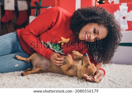 Stock fotó: Pretty Girl With Afro Hair Lies On Floor With Dog Expresses Pleasant Emotions Poses In Living Roo