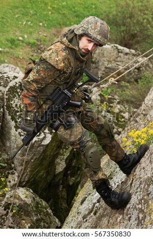 Stock photo: Armed Soldier Hanging On The Rope