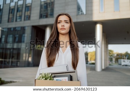 Stock foto: Uncertain Woman Standing In Front Of A Modern Building