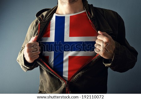 Stok fotoğraf: Man Stretching Jacket To Reveal Shirt With Norway Flag