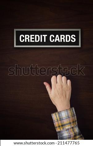 Stok fotoğraf: Hand Is Knocking On Credit Cards Door