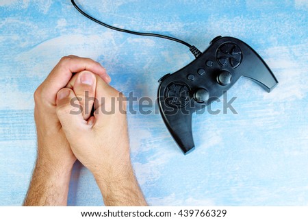 [[stock_photo]]: Man Resisting Video Game Addiction