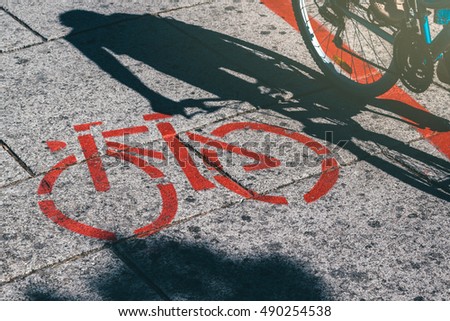 Сток-фото: Shadow Of Female Biker And Bicycle Route Road Marking