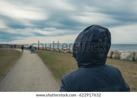 Stock fotó: Lonely Hooded Female Person From Behind Standing At Seashore