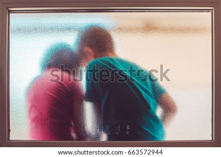 [[stock_photo]]: Unrecognizable Boy And Girl Behind Stained Glass Window