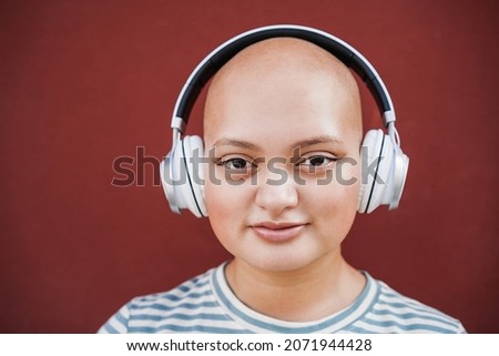 Happy Bald Asian Girl With Headphones Outdoors Stock foto © DisobeyArt